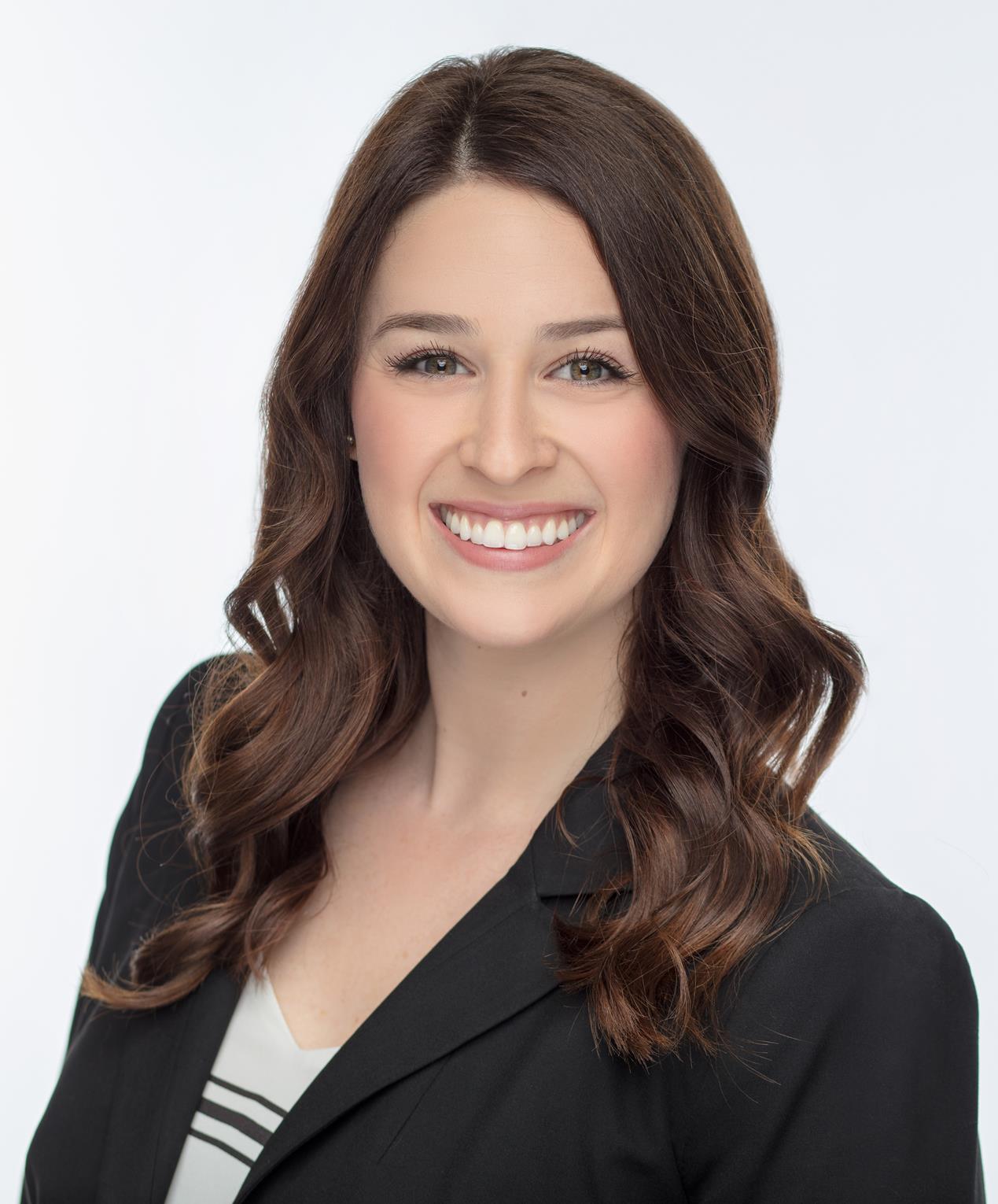 A female executive donning a business suit, radiating positivity with her smile.